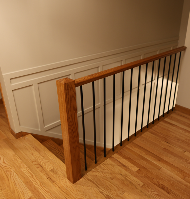 The finished renovated staircase with square newel posts and black iron balusters (2)