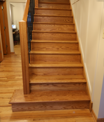 The finished renovated staircase with square newel posts and black iron balusters (3)